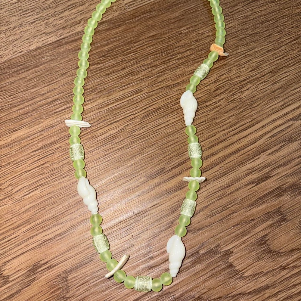 Green and white shell necklace with green beads and white shell-like beads